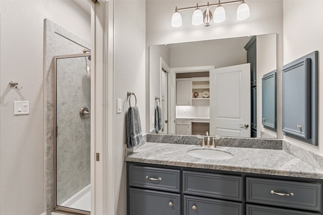 bathroom with vanity and a shower with shower door