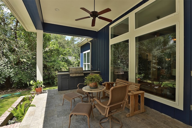 view of patio with area for grilling and ceiling fan