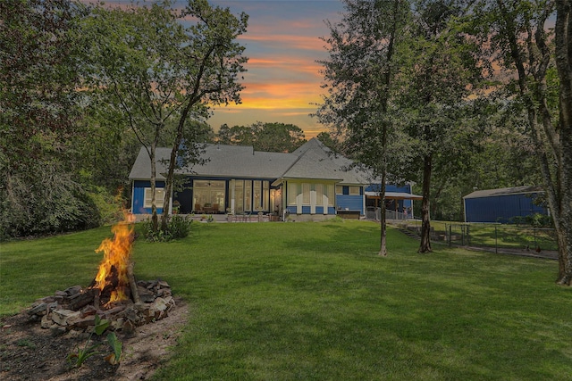 exterior space with a lawn and an outdoor fire pit