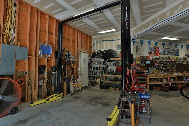 garage featuring a workshop area and electric panel