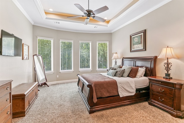 carpeted bedroom with a raised ceiling, ceiling fan, and ornamental molding