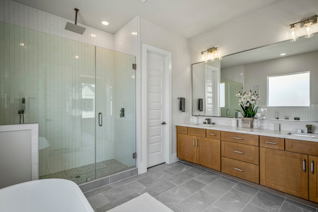 bathroom featuring vanity and shower with separate bathtub