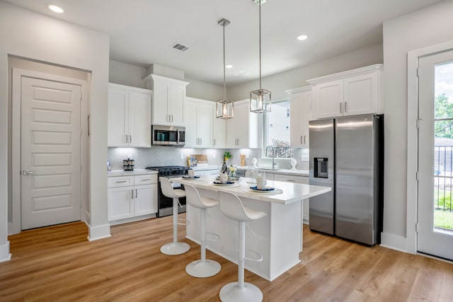 kitchen featuring hanging light fixtures, plenty of natural light, and stainless steel appliances