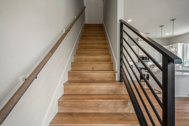 stairway featuring hardwood / wood-style flooring