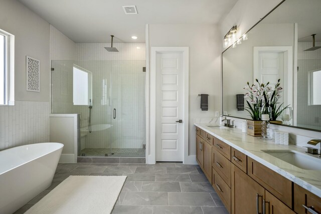 bathroom featuring vanity and plus walk in shower