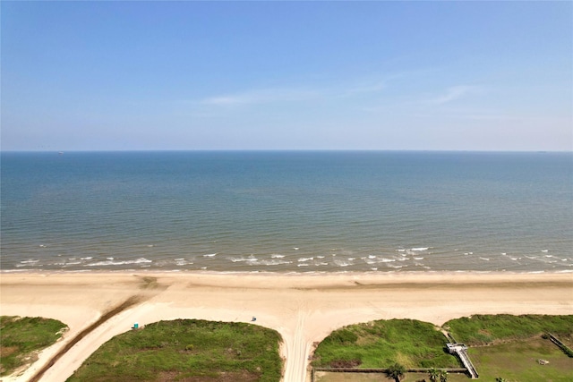 drone / aerial view with a beach view and a water view