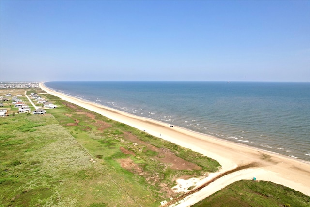 birds eye view of property featuring a beach view and a water view