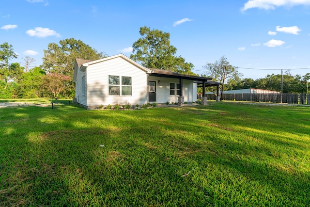 back of property featuring a yard