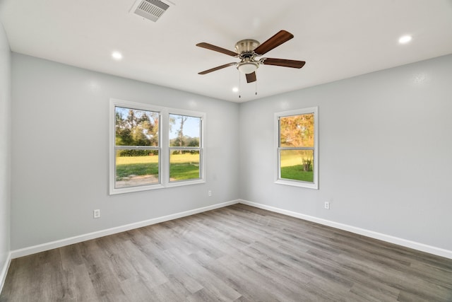 empty room with ceiling fan and wood-type flooring