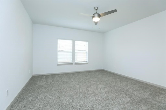 empty room featuring carpet floors and ceiling fan