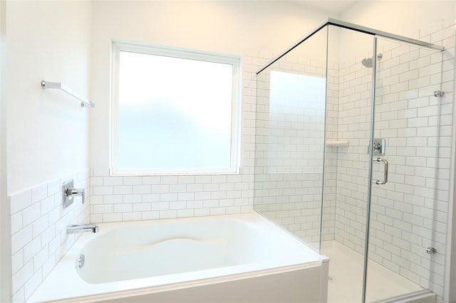 bathroom with separate shower and tub