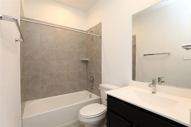 full bathroom featuring vanity, tiled shower / bath combo, and toilet