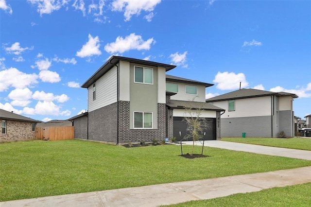 view of front of home with a garage and a front lawn