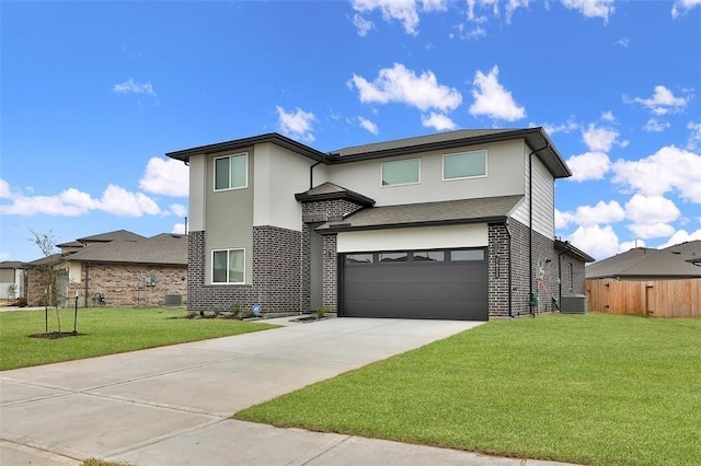 view of front of house featuring a front lawn, central AC, and a garage