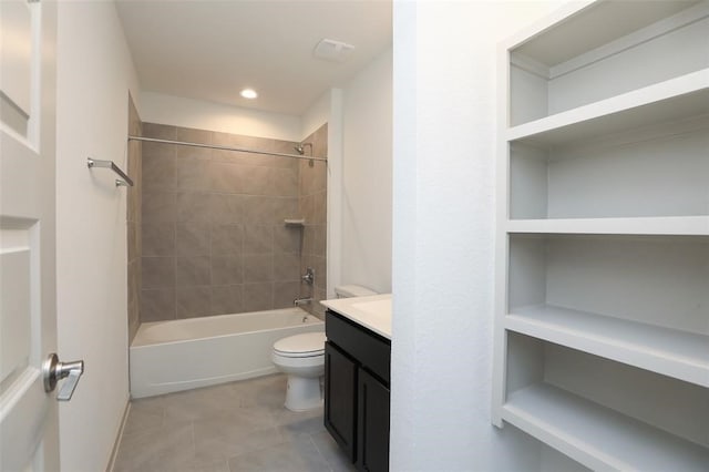 full bathroom with toilet, tiled shower / bath, vanity, and tile patterned floors