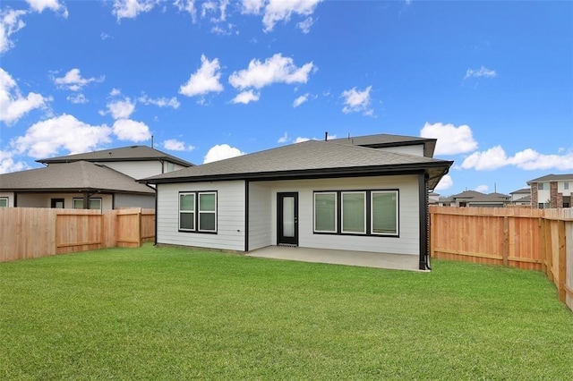 rear view of house featuring a patio area and a yard