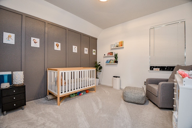 bedroom featuring a crib and light colored carpet