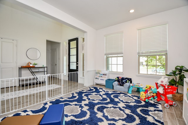 game room with light hardwood / wood-style floors