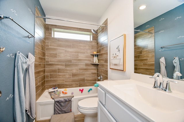 full bathroom featuring toilet, tiled shower / bath, and vanity