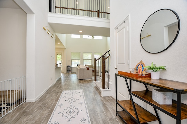 entrance foyer with a high ceiling and light hardwood / wood-style flooring