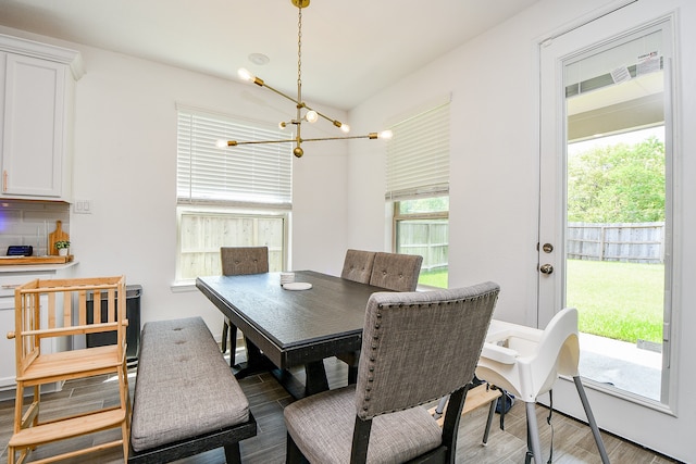 dining space featuring a wealth of natural light, hardwood / wood-style flooring, and a chandelier