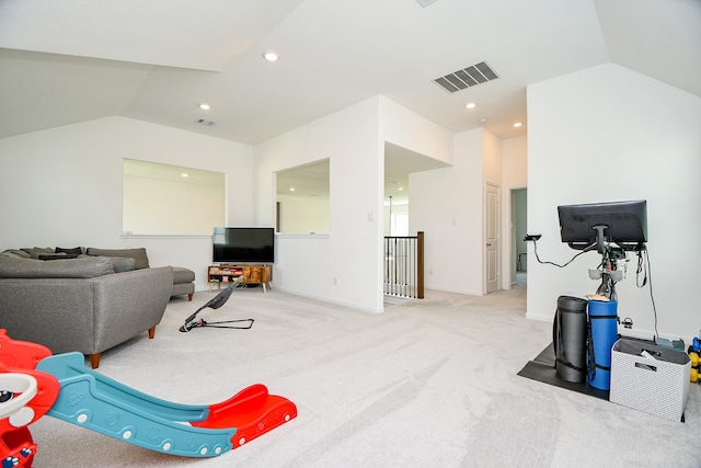 carpeted living room with lofted ceiling