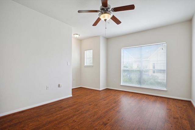 empty room with ceiling fan, wood-type flooring, and plenty of natural light