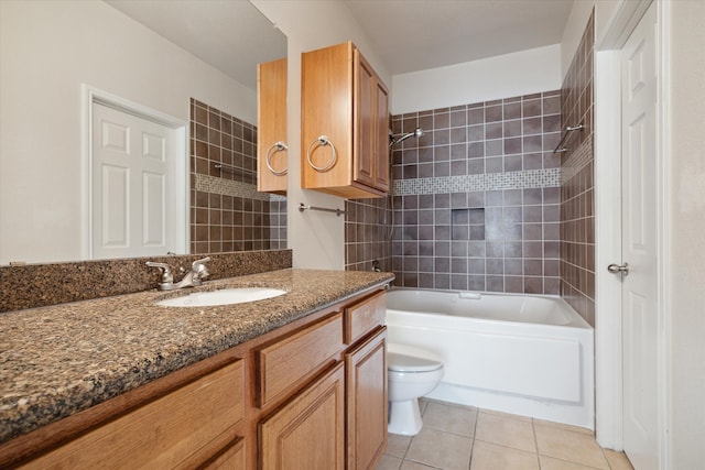 full bathroom featuring tile patterned flooring, vanity, tiled shower / bath combo, and toilet