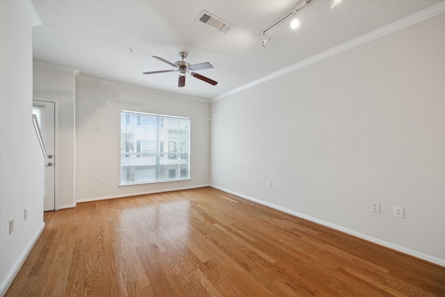 spare room featuring light hardwood / wood-style flooring, ceiling fan, ornamental molding, and track lighting