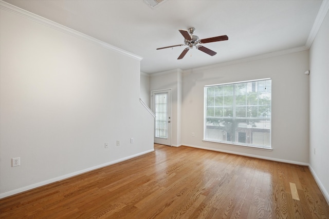 empty room featuring ceiling fan, crown molding, and light wood-type flooring