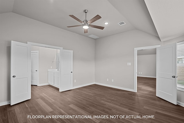 interior space featuring vaulted ceiling, ceiling fan, connected bathroom, and dark wood-type flooring