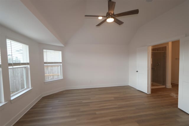 empty room featuring lofted ceiling, dark hardwood / wood-style floors, and ceiling fan