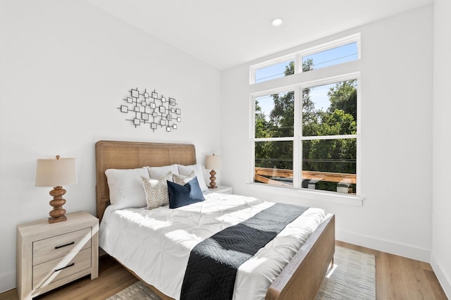 bedroom with recessed lighting, baseboards, and wood finished floors