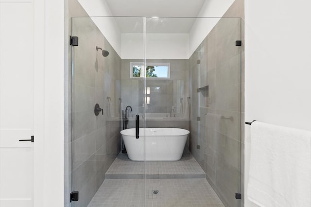 full bath featuring a soaking tub and a shower stall