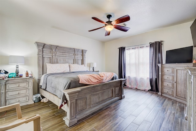 bedroom featuring ceiling fan and dark hardwood / wood-style floors