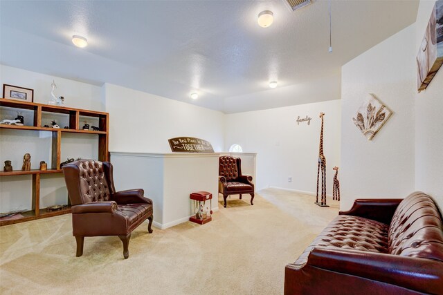 living area featuring carpet, visible vents, and baseboards