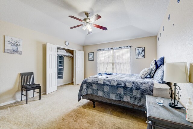 carpeted bedroom with lofted ceiling, ceiling fan, and a closet