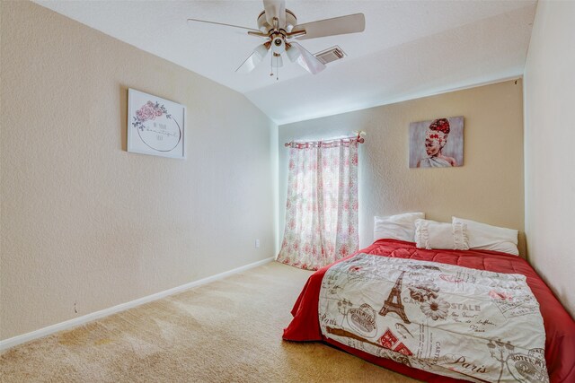 carpeted bedroom featuring ceiling fan and vaulted ceiling