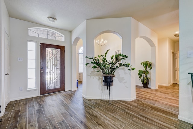 entryway with hardwood / wood-style floors and a textured ceiling