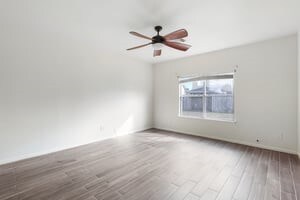 unfurnished room featuring hardwood / wood-style floors and ceiling fan