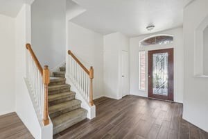 entryway with stairs and wood finished floors