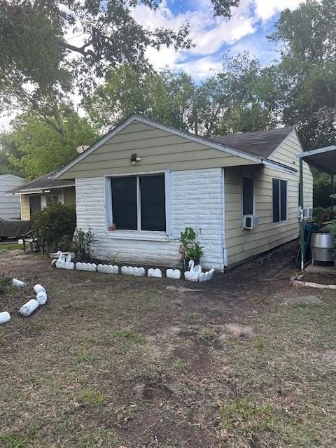 view of front of property with stone siding and cooling unit