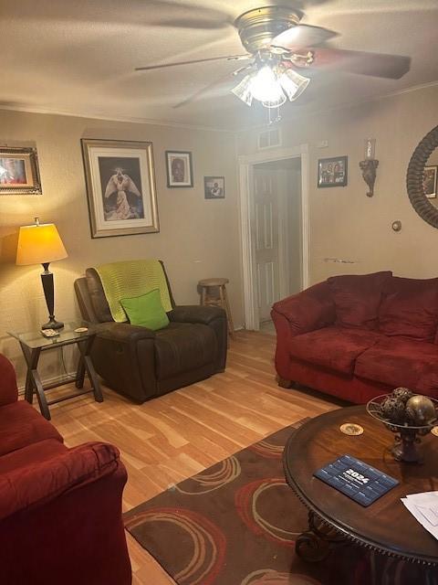 living room featuring ceiling fan and wood-type flooring