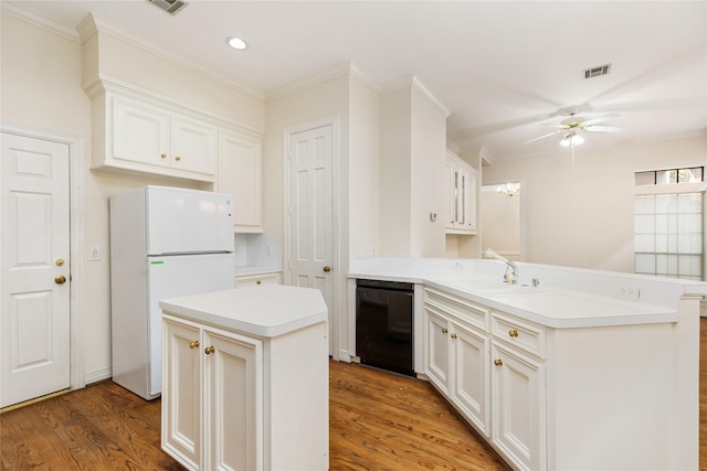 kitchen featuring a kitchen island, dishwasher, sink, white fridge, and kitchen peninsula