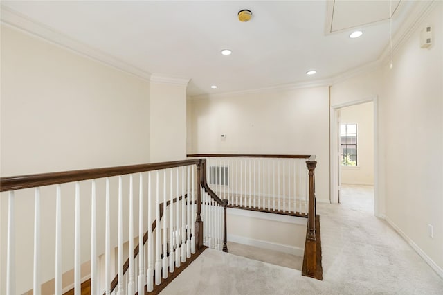 corridor featuring crown molding and light colored carpet