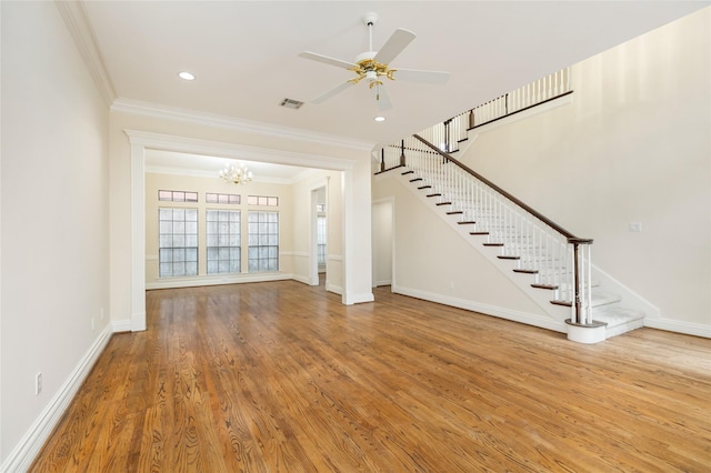 unfurnished living room featuring ceiling fan with notable chandelier, ornamental molding, and hardwood / wood-style floors