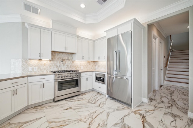 502 Amalfi Dr, Kemah, TX 77565 - kitchen with high quality appliances, light marble finish flooring, crown molding, light countertops, and recessed lighting