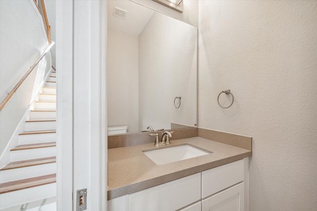 bathroom with toilet and vanity