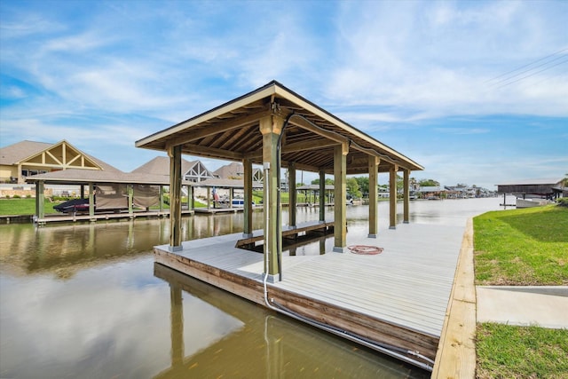 dock area with a water view and boat lift