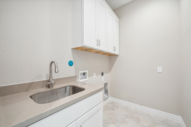 laundry room with sink, electric dryer hookup, washer hookup, cabinets, and light tile patterned floors